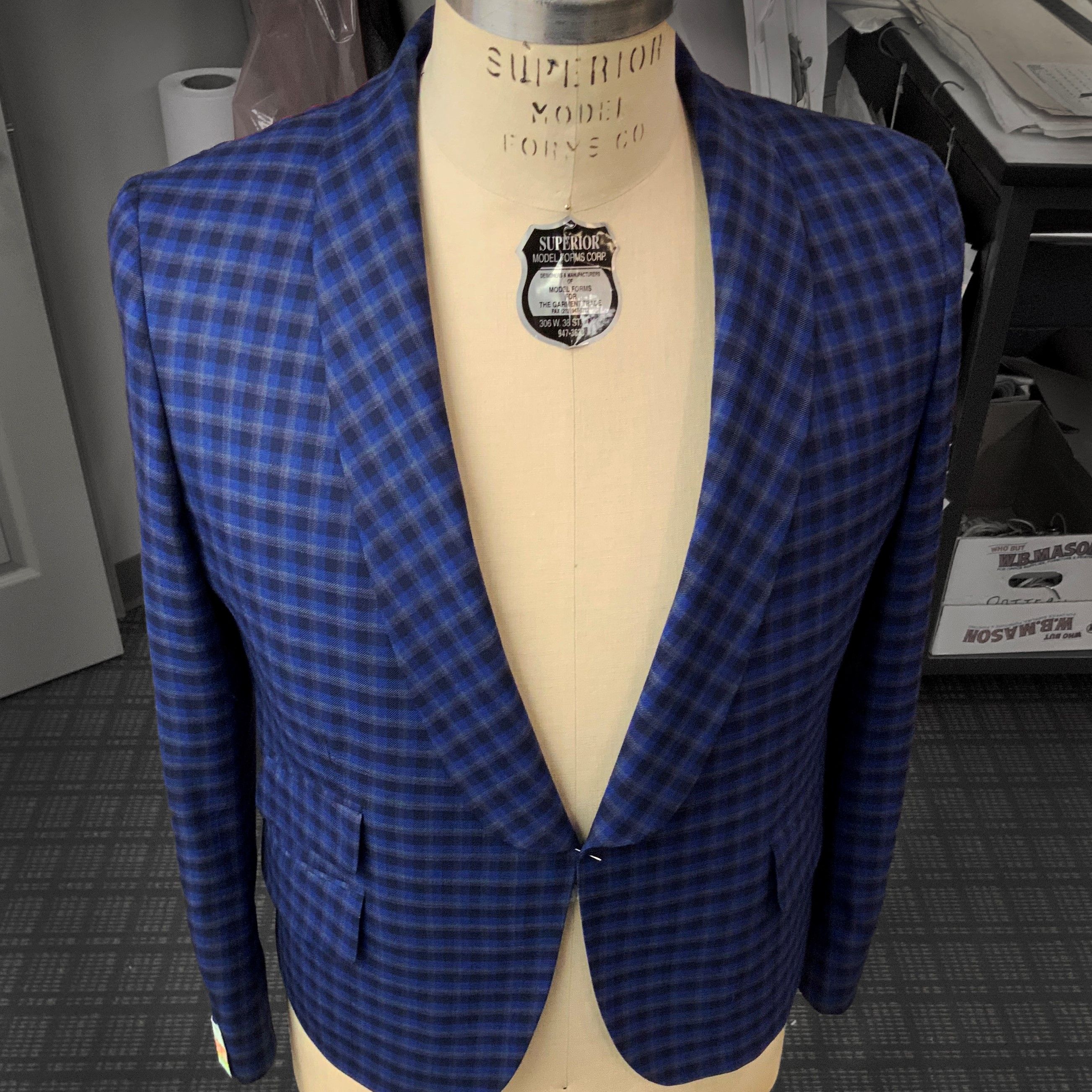 A mannequin displaying a blue suit jacket.