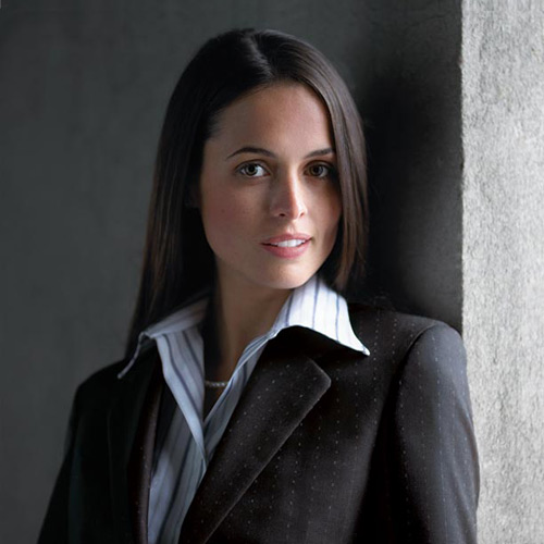 A woman wearing a dark gray jacket.